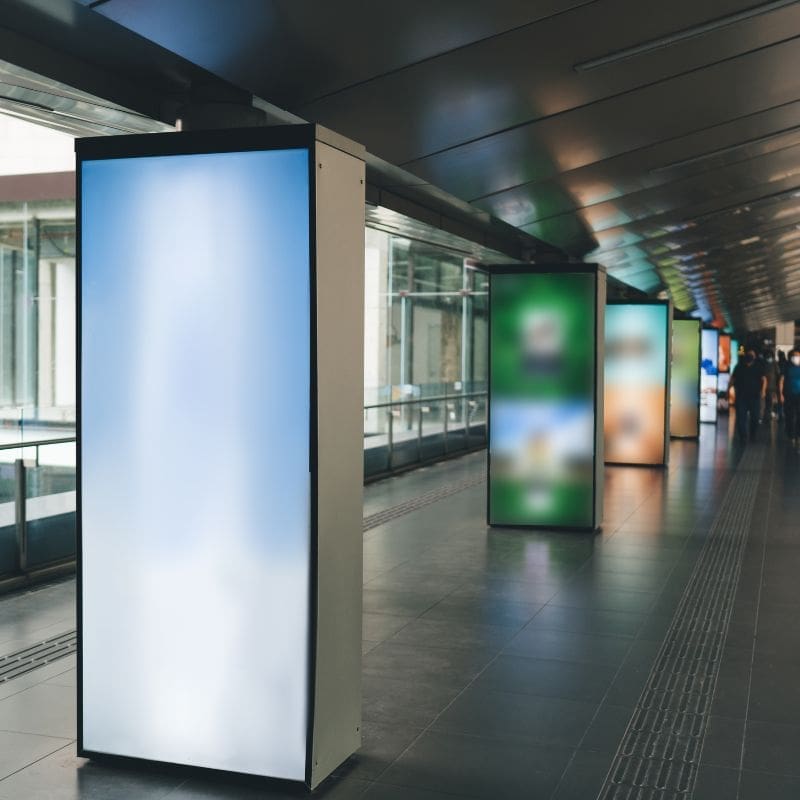 Transparent LED screen wall inside a commercial space with a city street visible through the glass panels.