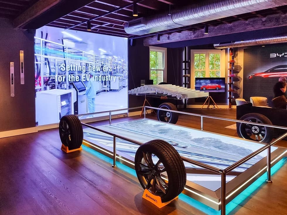 BYD automotive showroom installation with LED video walls highlighting electric vehicle innovation and technology.