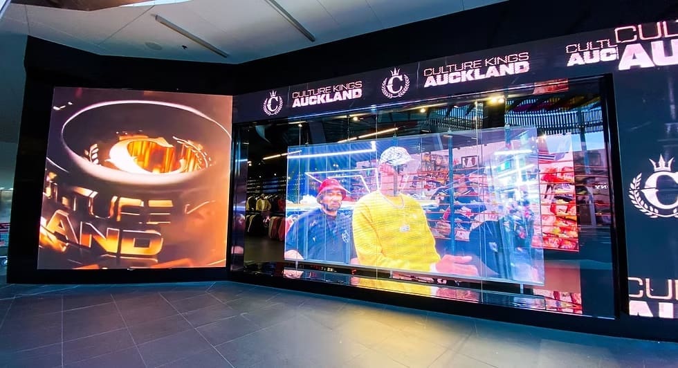 Exterior of Culture Kings Auckland with transparent LED display showing dynamic retail video content.