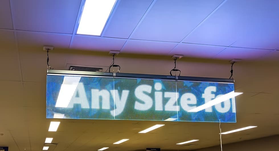 Indoor LED display hanging from the ceiling at Forty Winks store showing promotional content.
