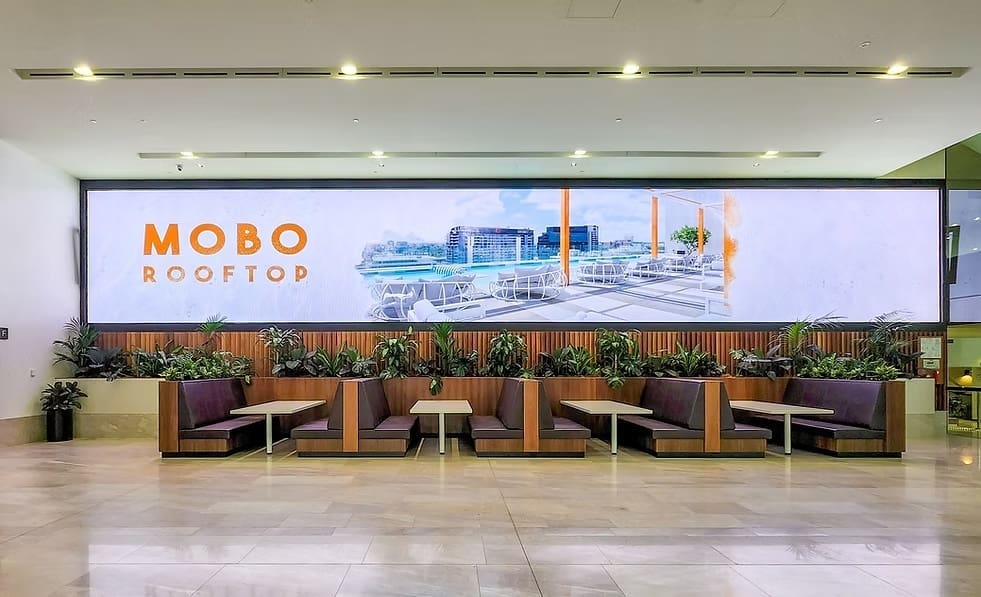 MOBO Rooftop restaurant LED wall display featuring panoramic visuals and indoor seating area.