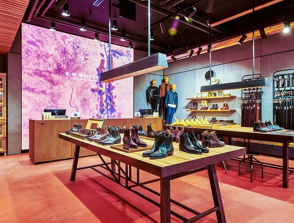 Full view of R.M. Williams storefront with LED display at the back highlighting the brand’s Australian roots.