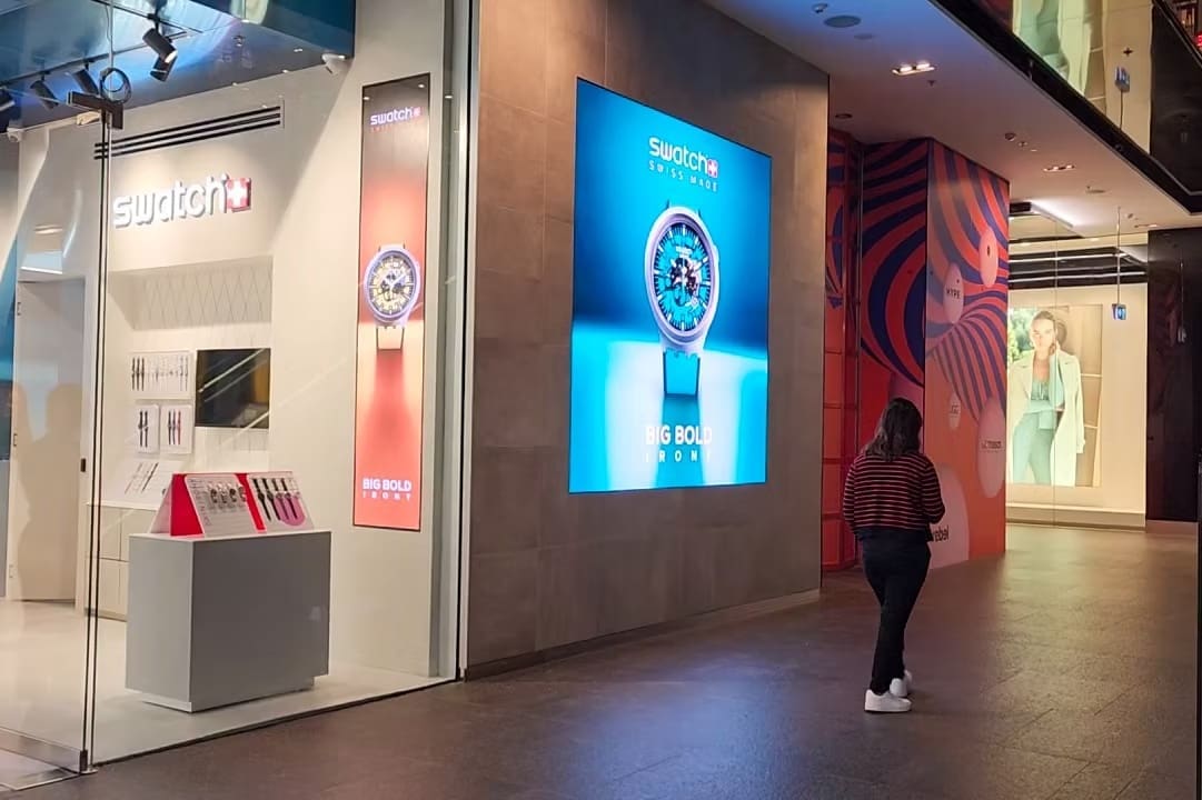 Swatch Sydney storefront with LED digital wall showcasing a watch advertisement titled “Big Bold Irony.”