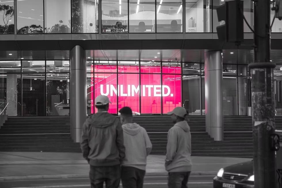 Exterior of Western Sydney University building with large LED screen displaying the word “UNLIMITED” in bright red.